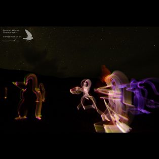 Penguins drawn in the dark with glow sticks